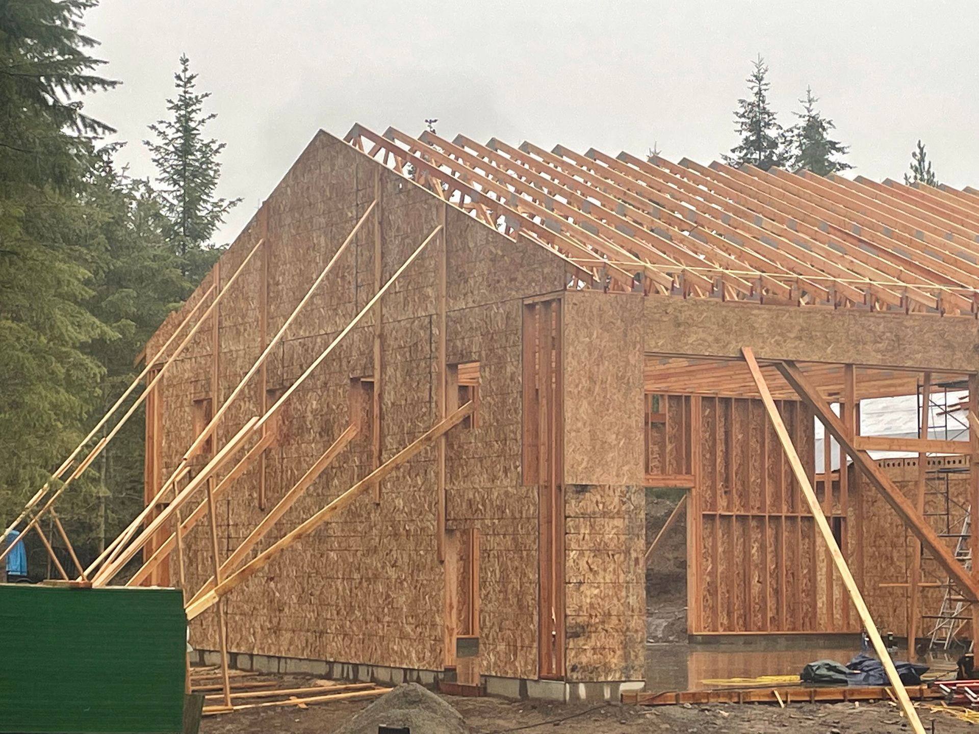 A house is being built with a green box in the foreground.