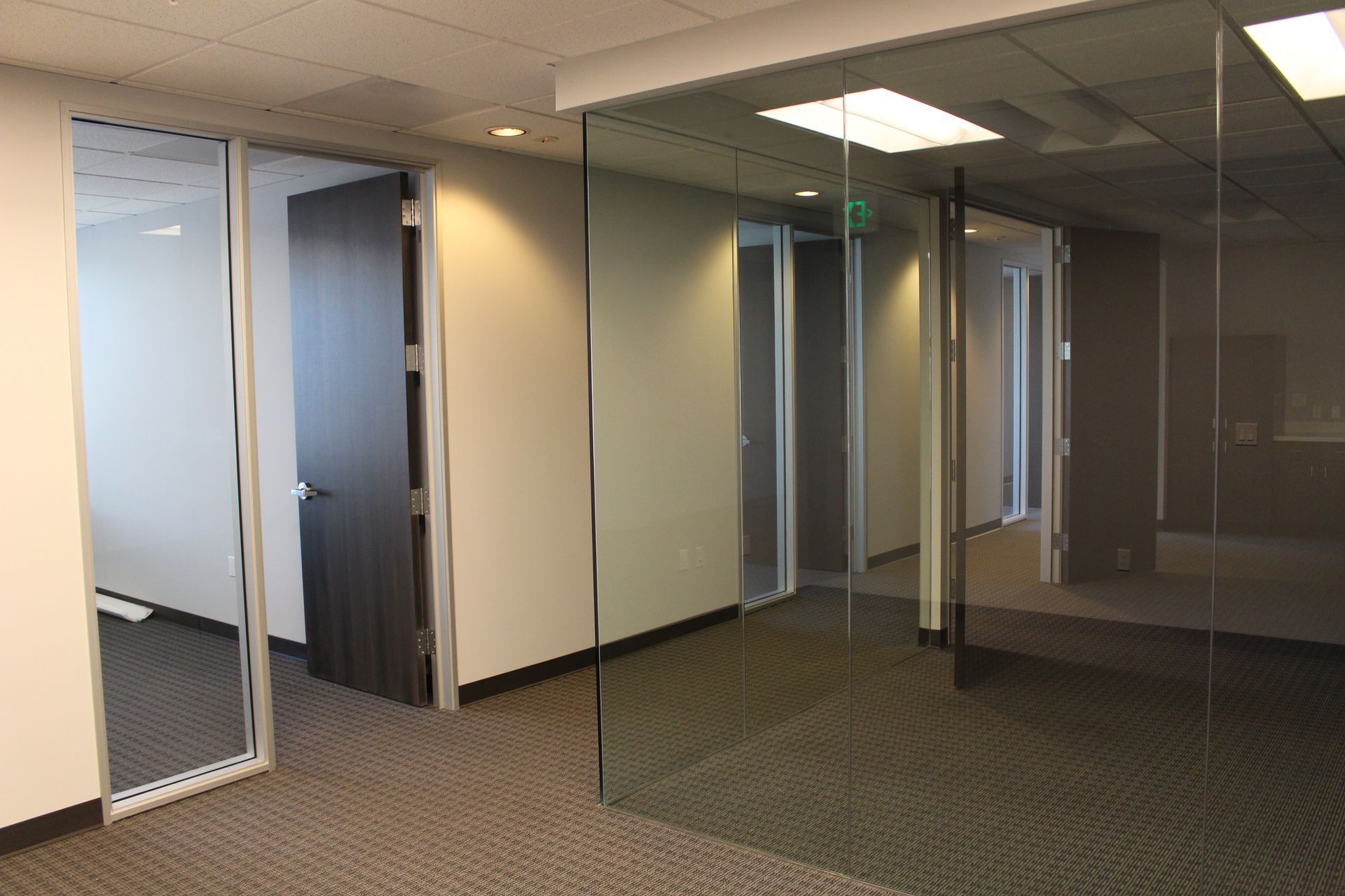 An empty office with a glass wall and a door