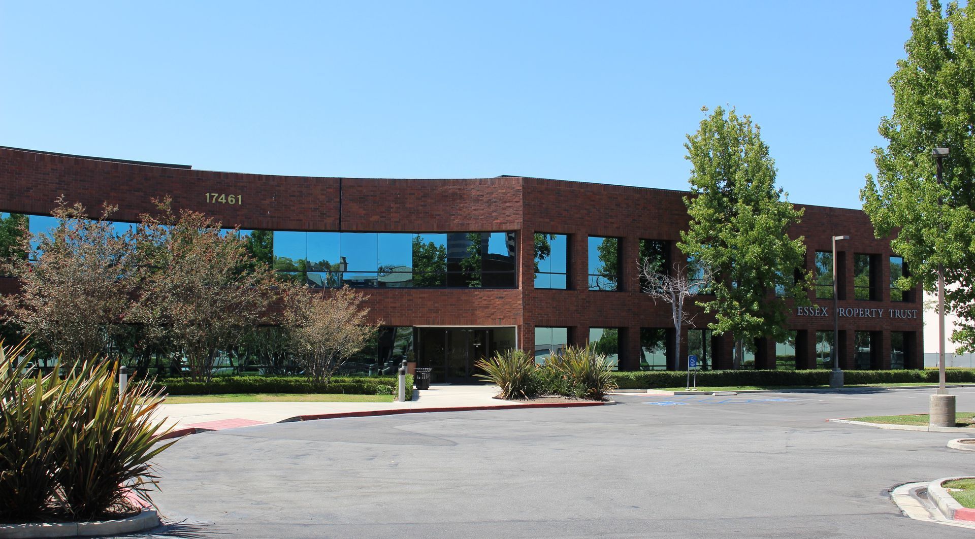 A large brick building with a parking lot in front of it
