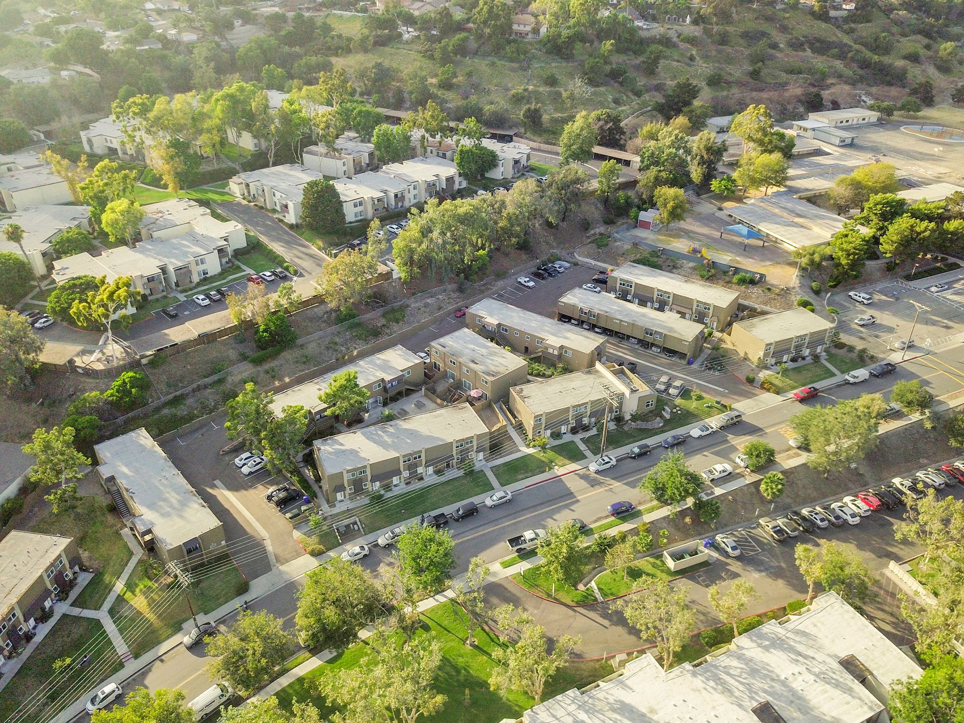 An aerial view of a residential area with lots of buildings and trees.