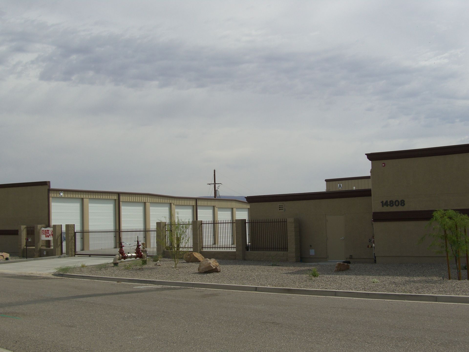 A building with a fence and a sign that says no parking