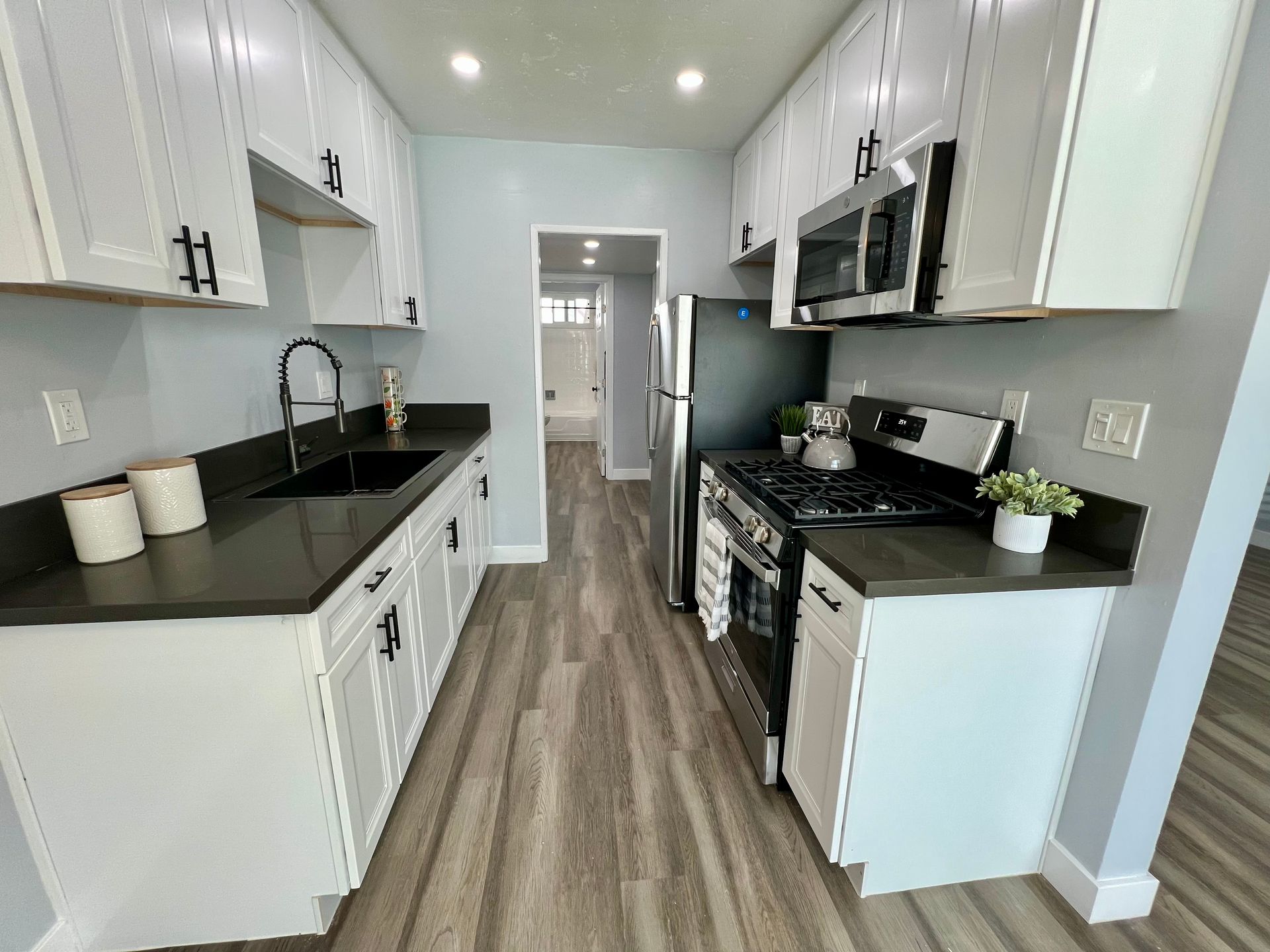 A kitchen with white cabinets and stainless steel appliances.