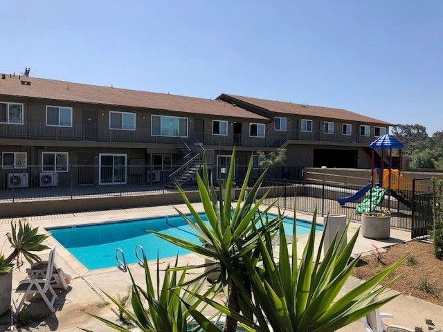 A large building with a swimming pool in front of it