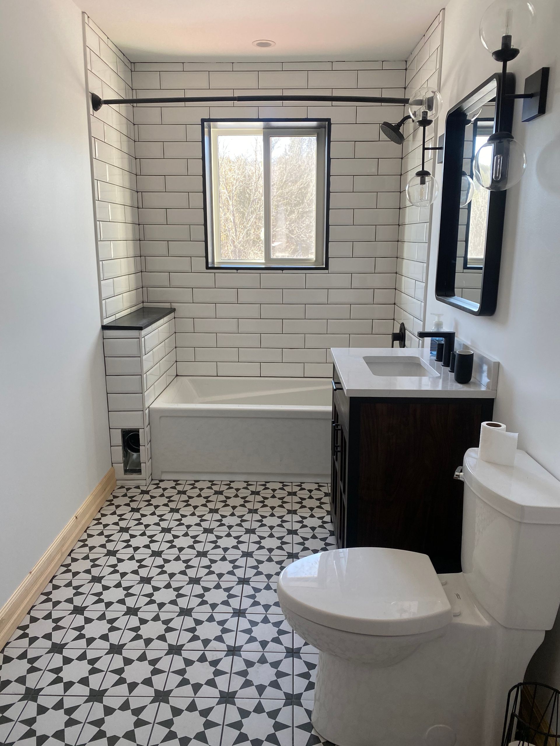 A bathroom with a toilet , sink and bathtub