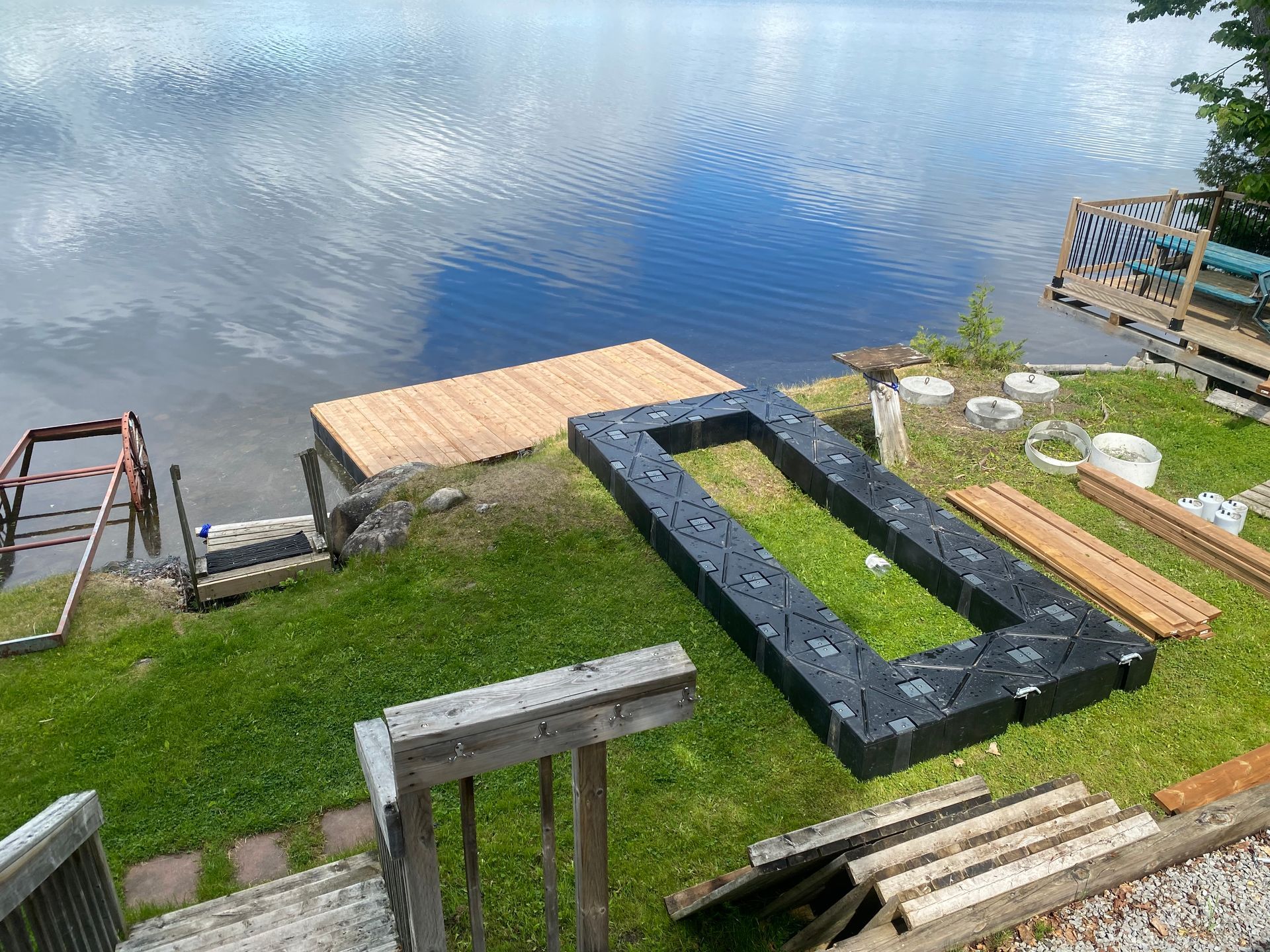 A dock is being built on the shore of a lake.