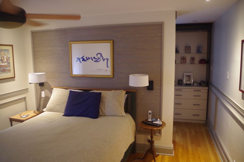 A bedroom with a bed and a picture on the wall that says ramsey