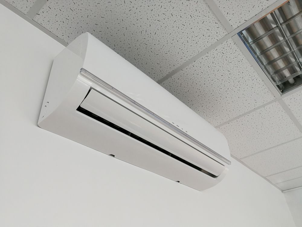 White Wall-mounted Air Conditioner on a Drop Ceiling — A & T Air-Conditioning and Refrigeration in Millbank, QLD
