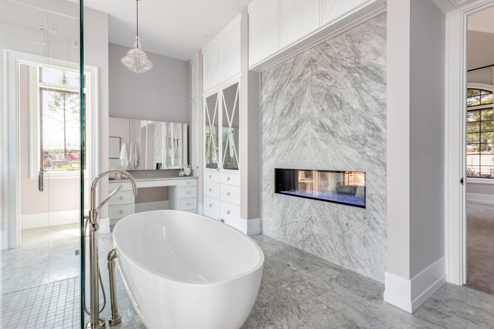 A bathroom with a tub and a fireplace.