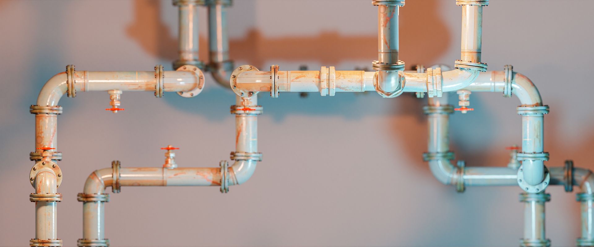 Metal pipes and valves form a structured commercial plumbing system with multiple connections.