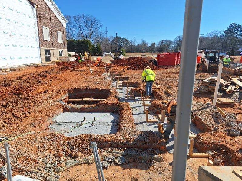A group of construction workers are working on a construction site.