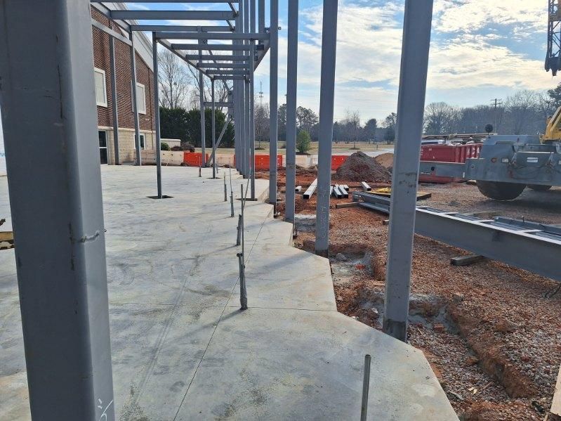 A metal structure is being built on a construction site