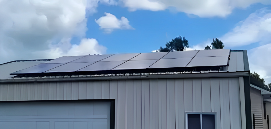 A garage with a lot of solar panels on the roof.