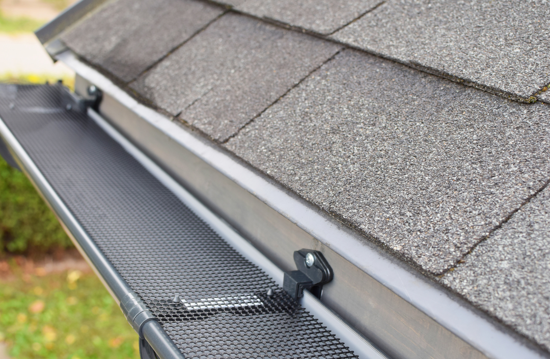 A close up of a gutter on the roof of a house.