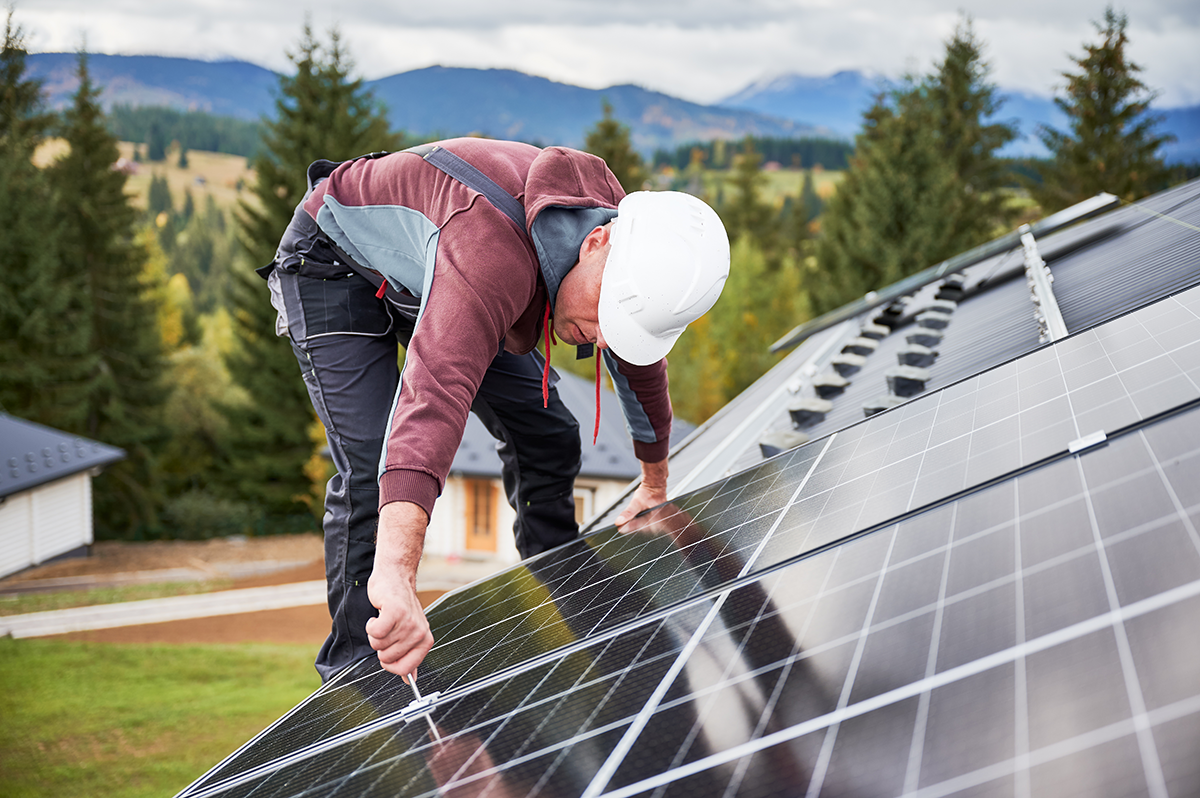 man installing solar panel