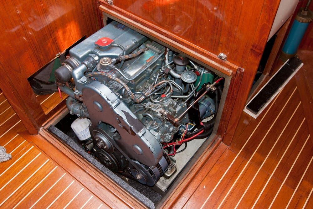 A Boat Engine is Sitting in a Wooden Cabinet on a Wooden Floor — ElectroMech Machine in Woolner, NT