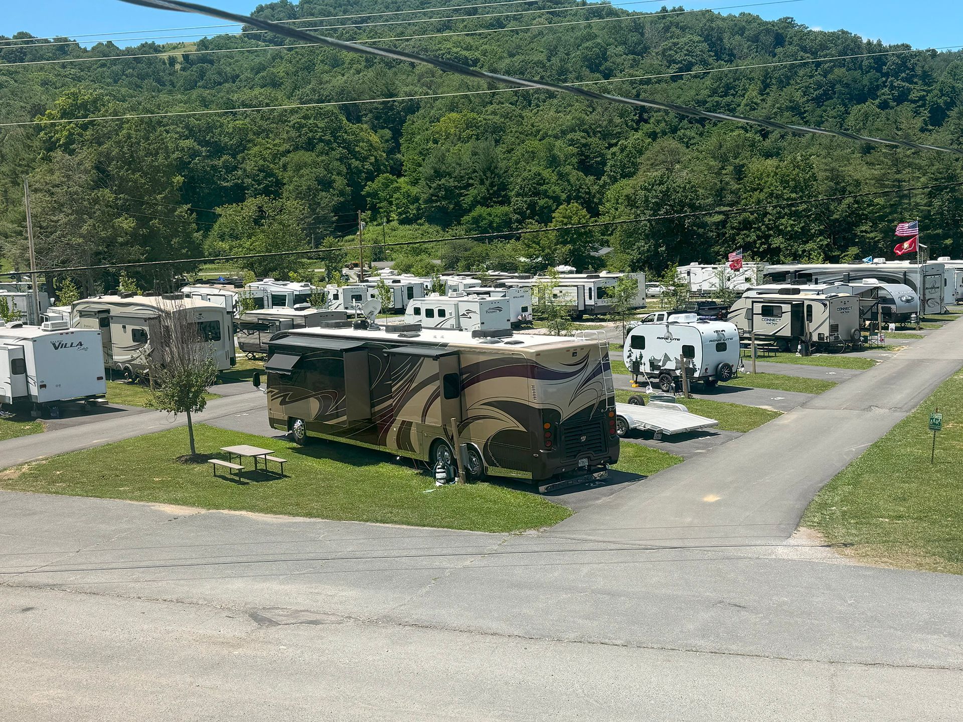 A lot of rv 's are parked in a campground.