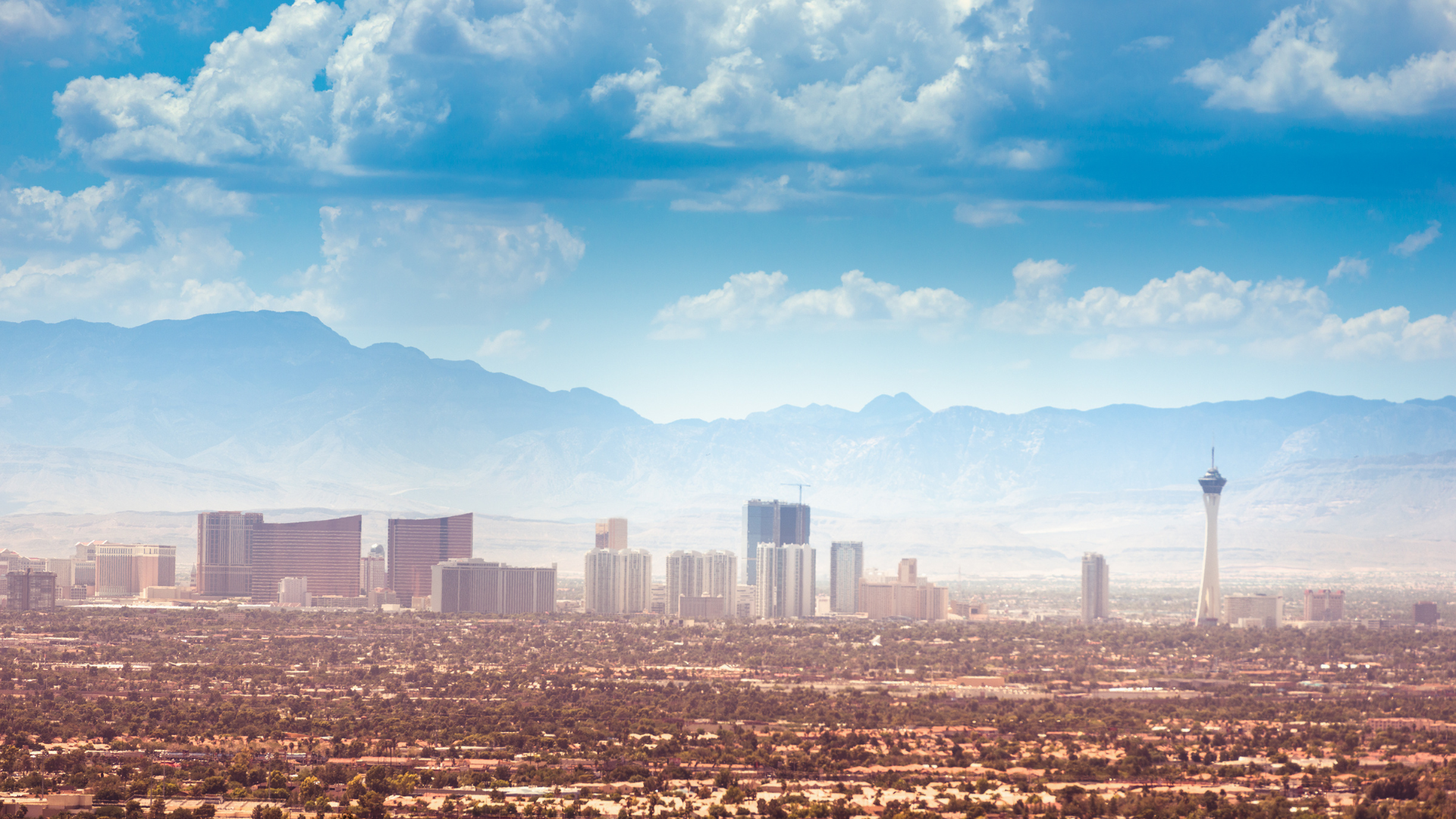 A view of the Las Vegas business district and valley landscape from a modern corporate office window.

