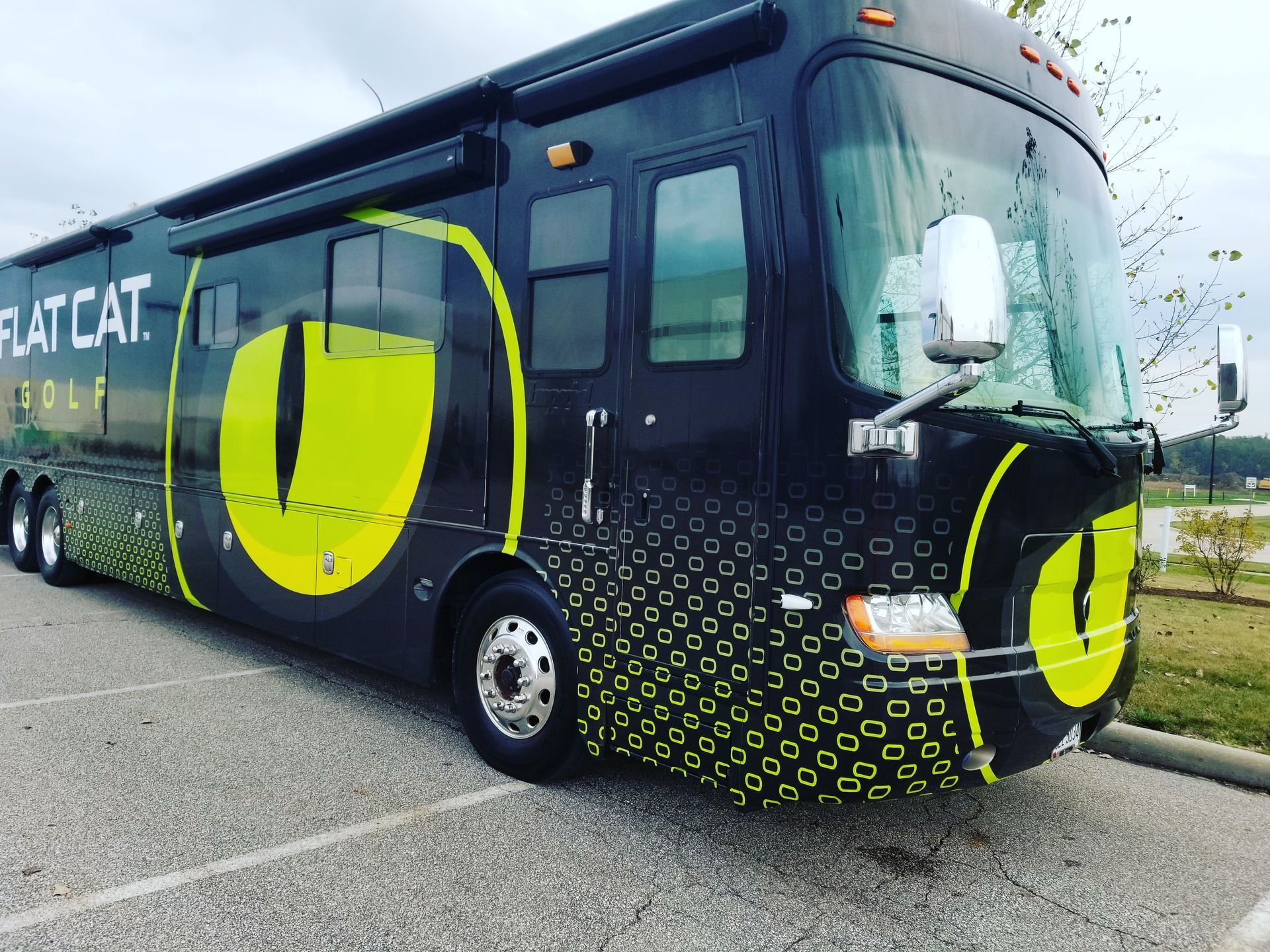a person is applying a protective film to the hood of a car .