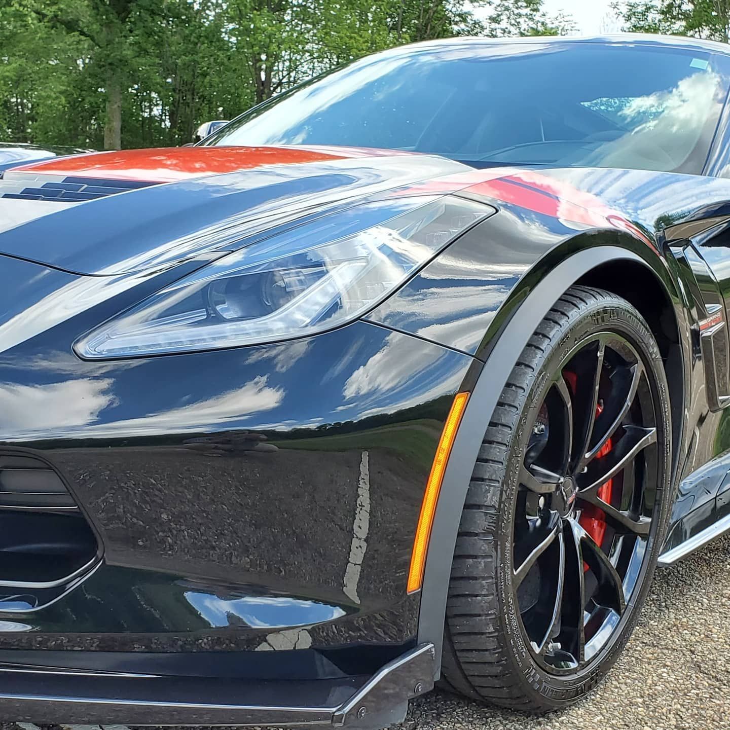 a gray sports car is parked in a showroom .