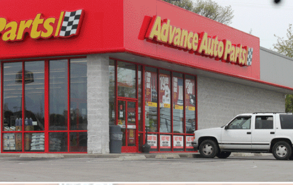 A White Car Is Parked In Front Of An Advance Auto Parts Store — Somerset, KY — Somerset Burnside Garage Door & Glass Co Inc