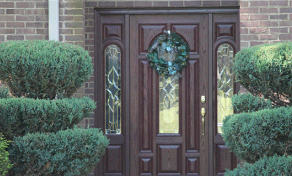 The Front Door Of A Brick House With A Wreath On It — Somerset, KY — Somerset Burnside Garage Door & Glass Co Inc