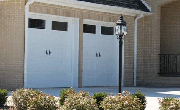 A House With Two White Garage Doors And A Lamp Post — Somerset, KY — Somerset Burnside Garage Door & Glass Co Inc