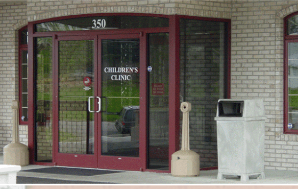 The Front Door Of A Children's Clinic With A Trash Can In Front Of It — Somerset, KY — Somerset Burnside Garage Door & Glass Co Inc