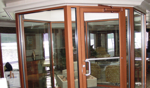 A Room With A Lot Of Windows And A Door — Somerset, KY — Somerset Burnside Garage Door & Glass Co Inc