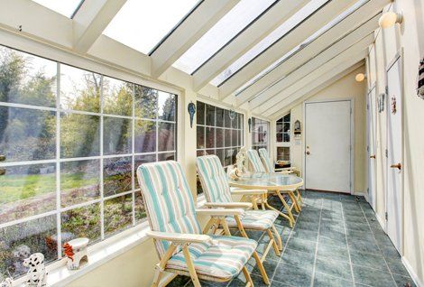A conservatory with garden furniture inside