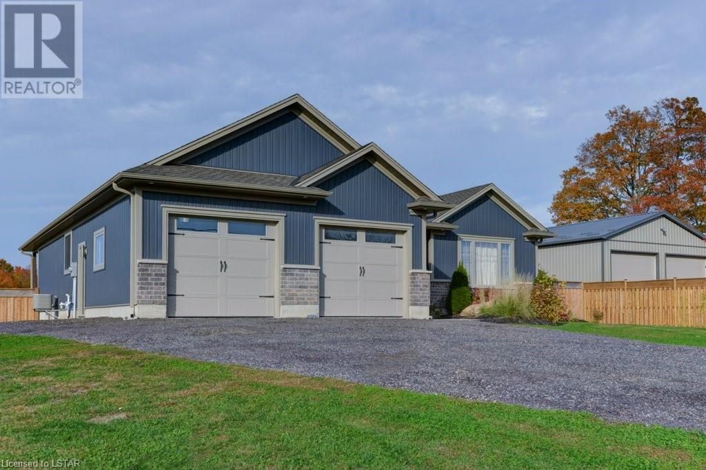 A large blue house with two garages is for sale.