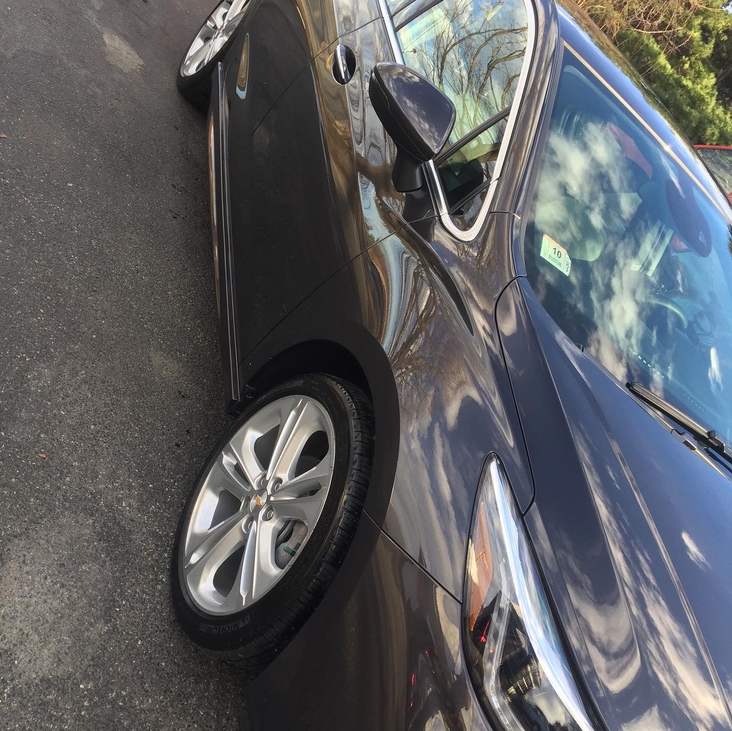 A black car is parked on the side of the road