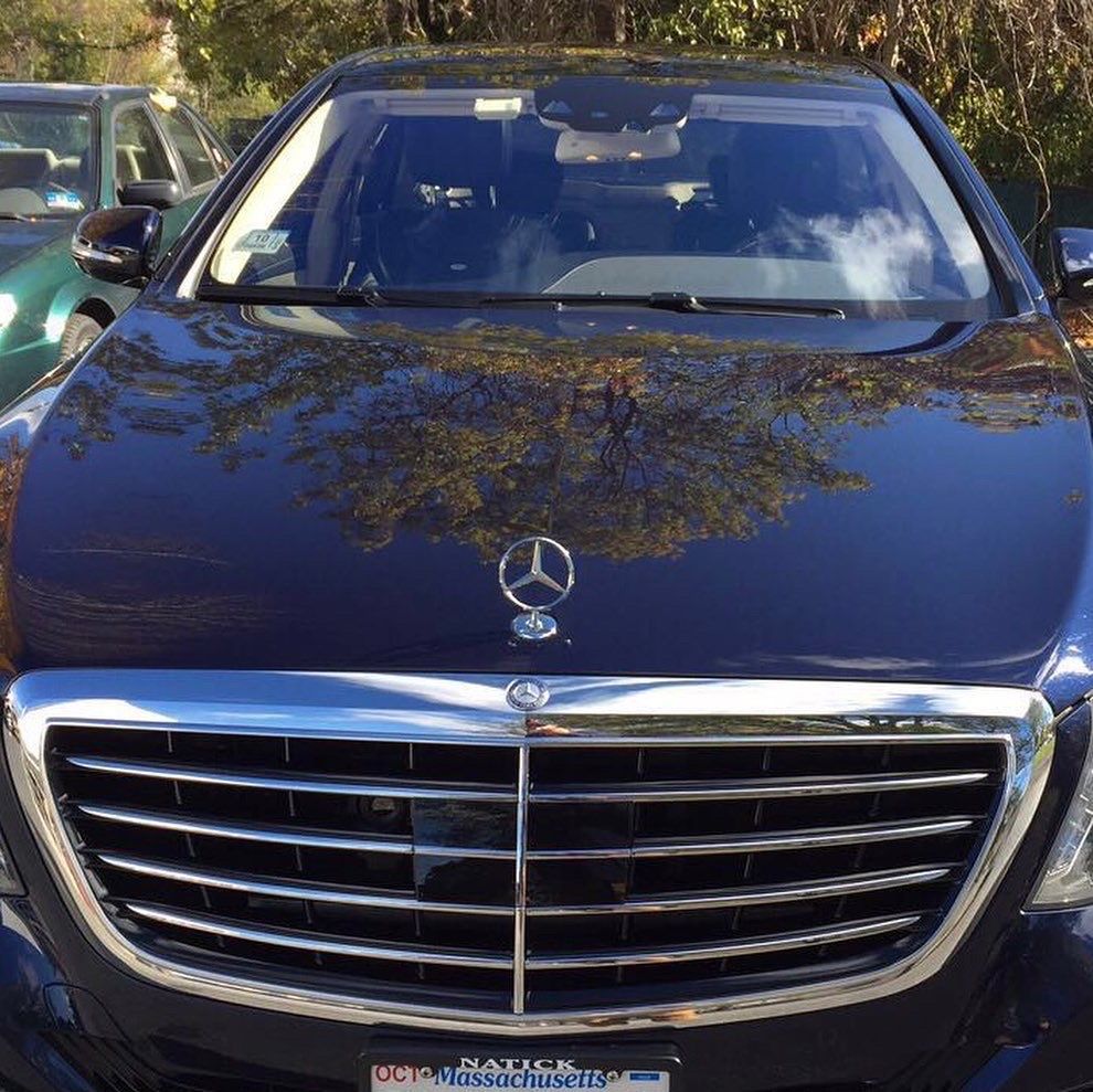 A black mercedes with a massachusetts license plate