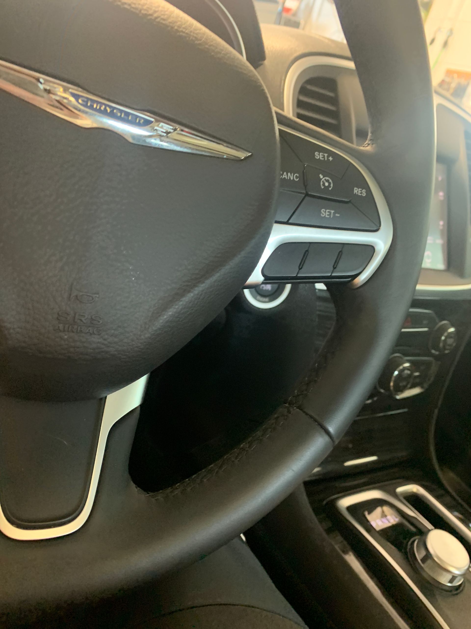 A close up of a steering wheel in a car