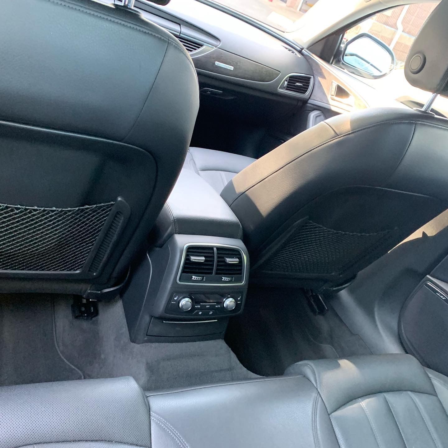 The back seat of a car with a rear air vent