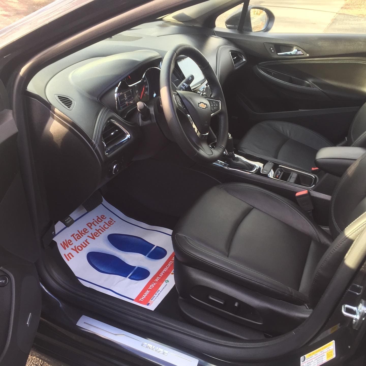 The inside of a car with a paper that says we take pride in your vehicle