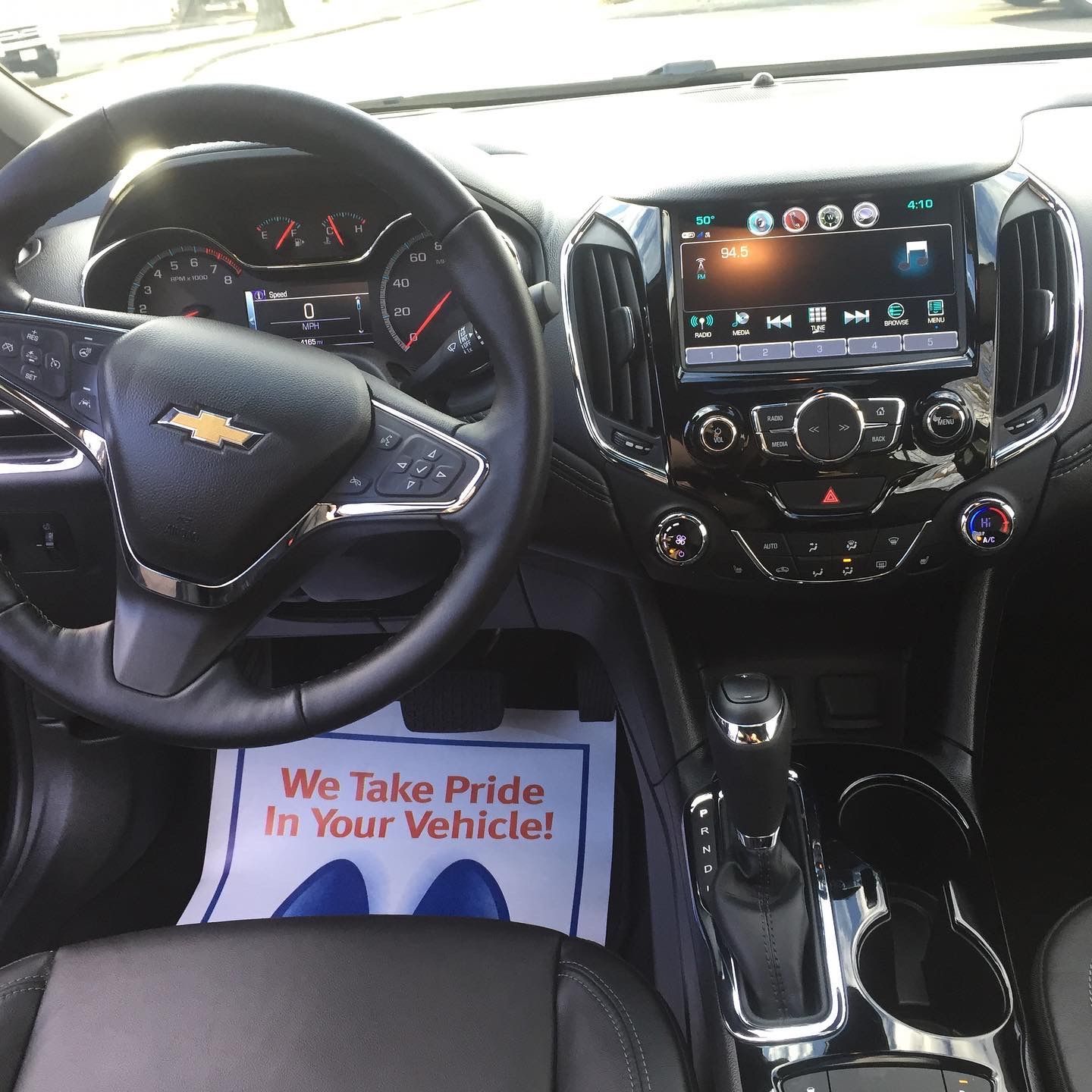 The inside of a car with a paper that says we take pride in your vehicle