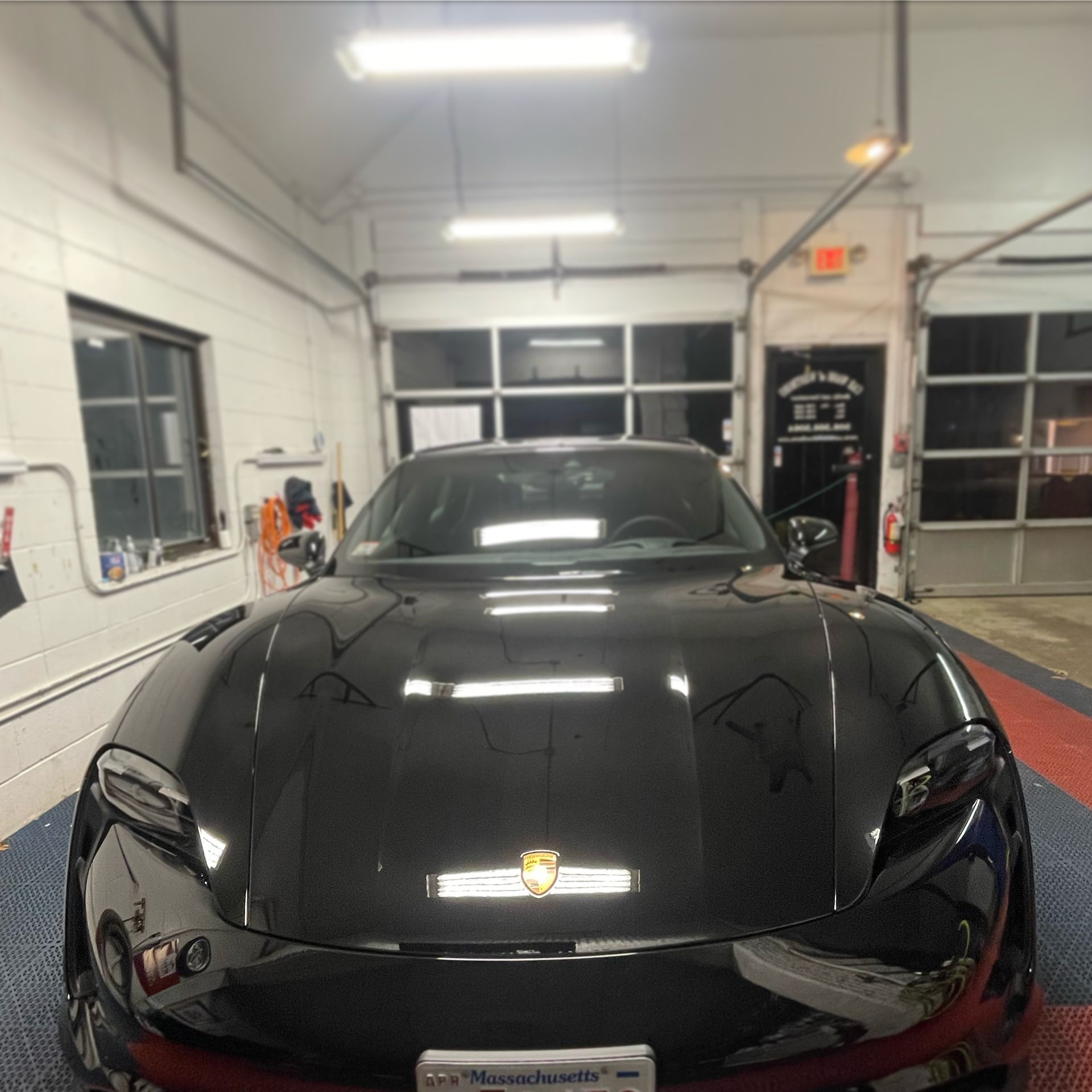 A black car with a license plate that says massachusetts