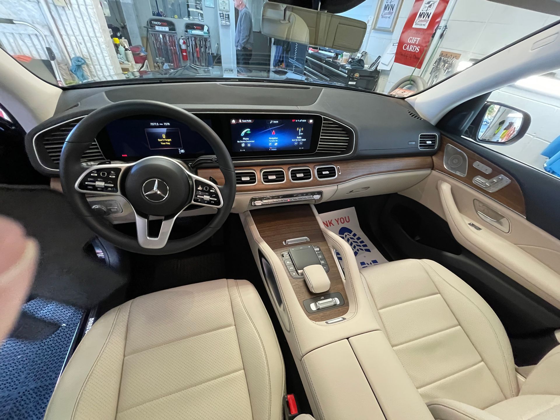 The interior of a mercedes benz gls is shown in a showroom.