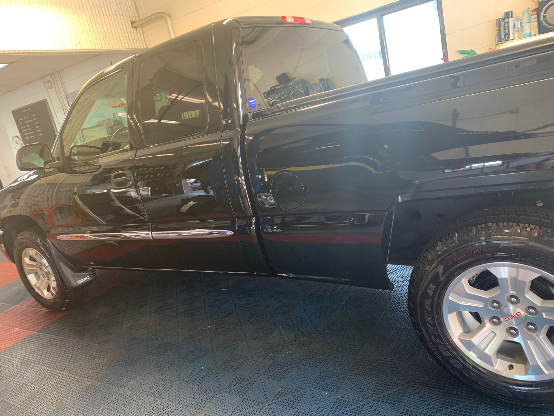 A black pickup truck is parked in a garage.
