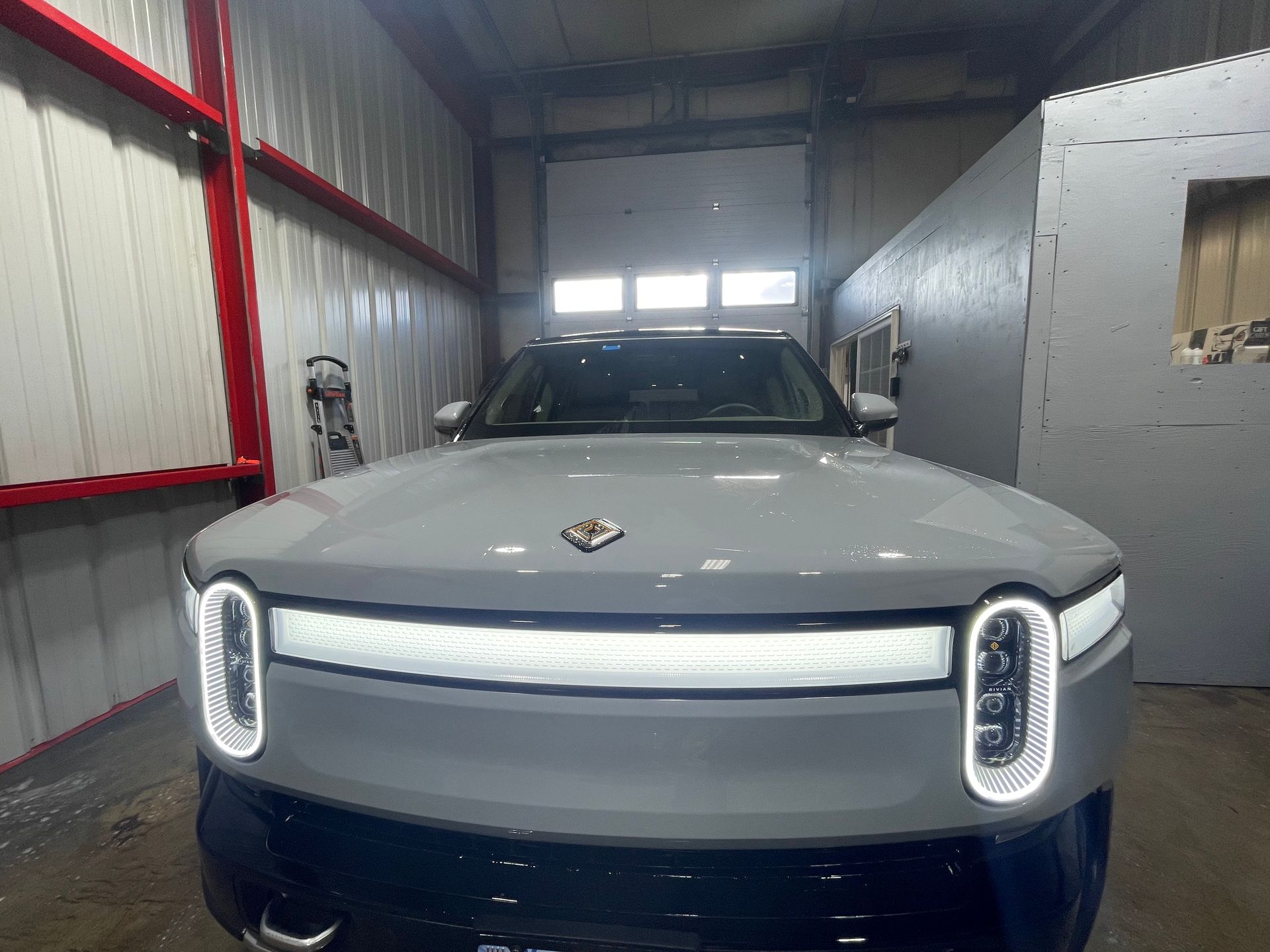 A gray suv is parked in a garage.