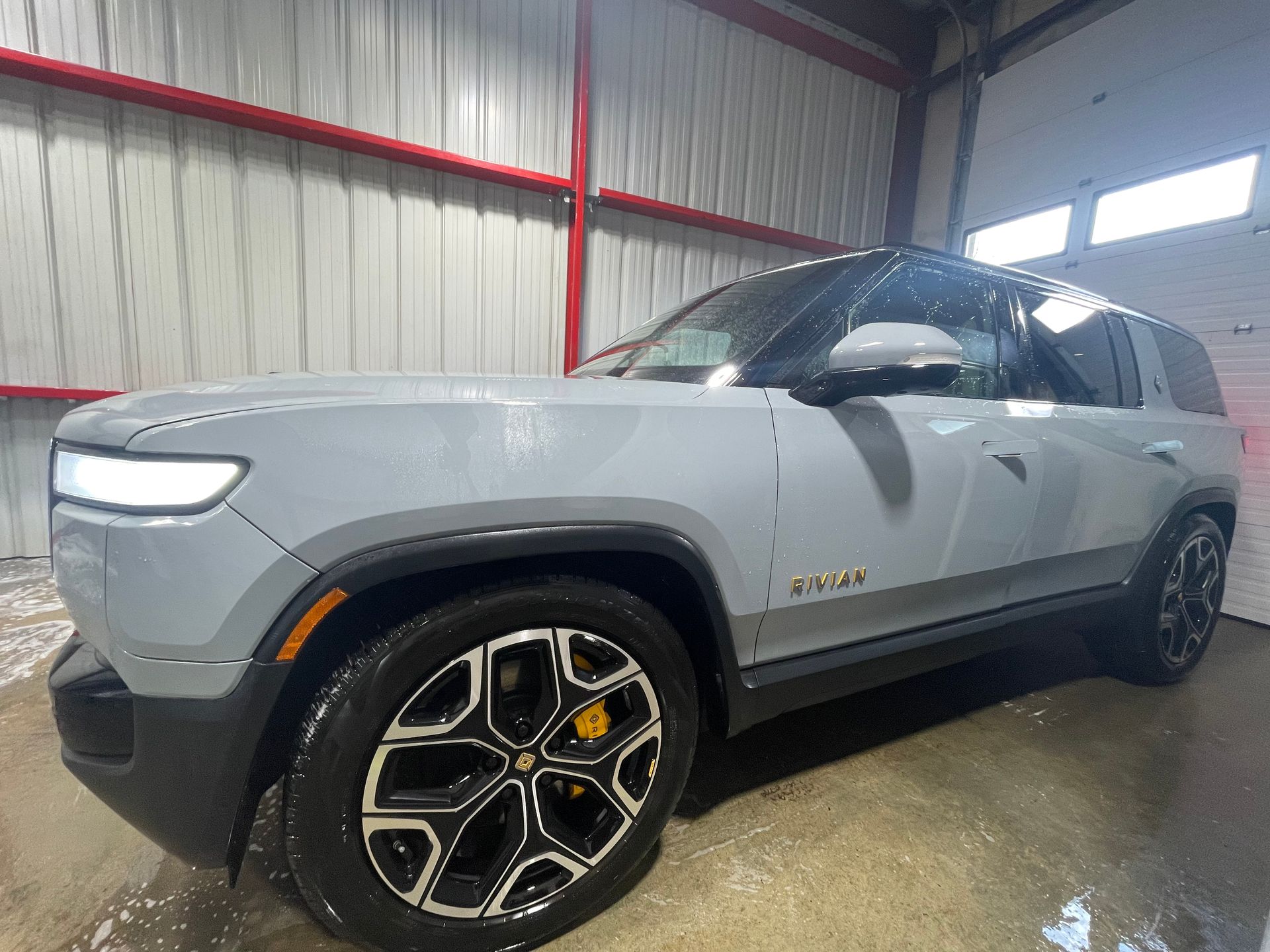 A gray suv is parked in a garage.