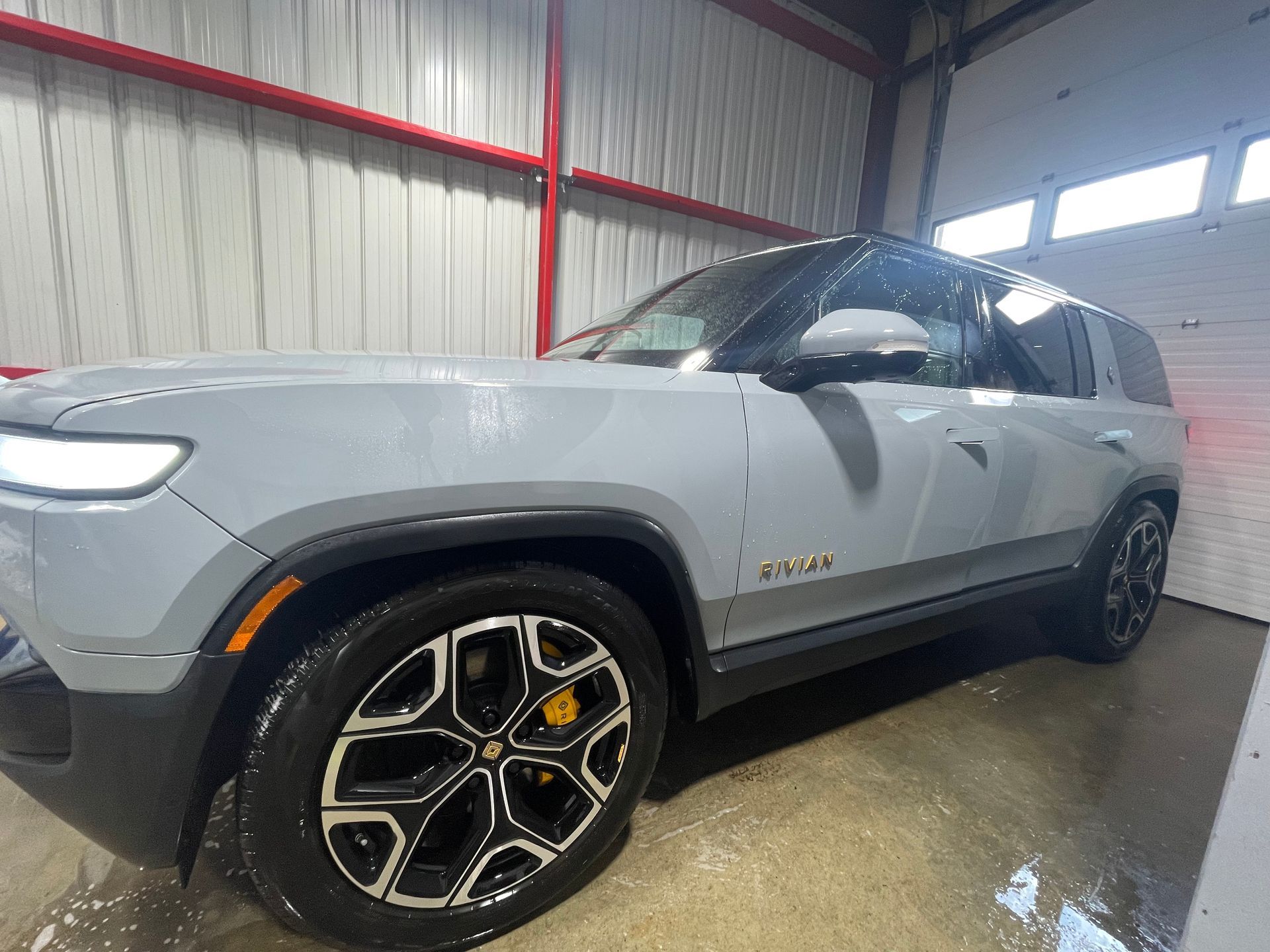 A gray suv is parked in a garage.