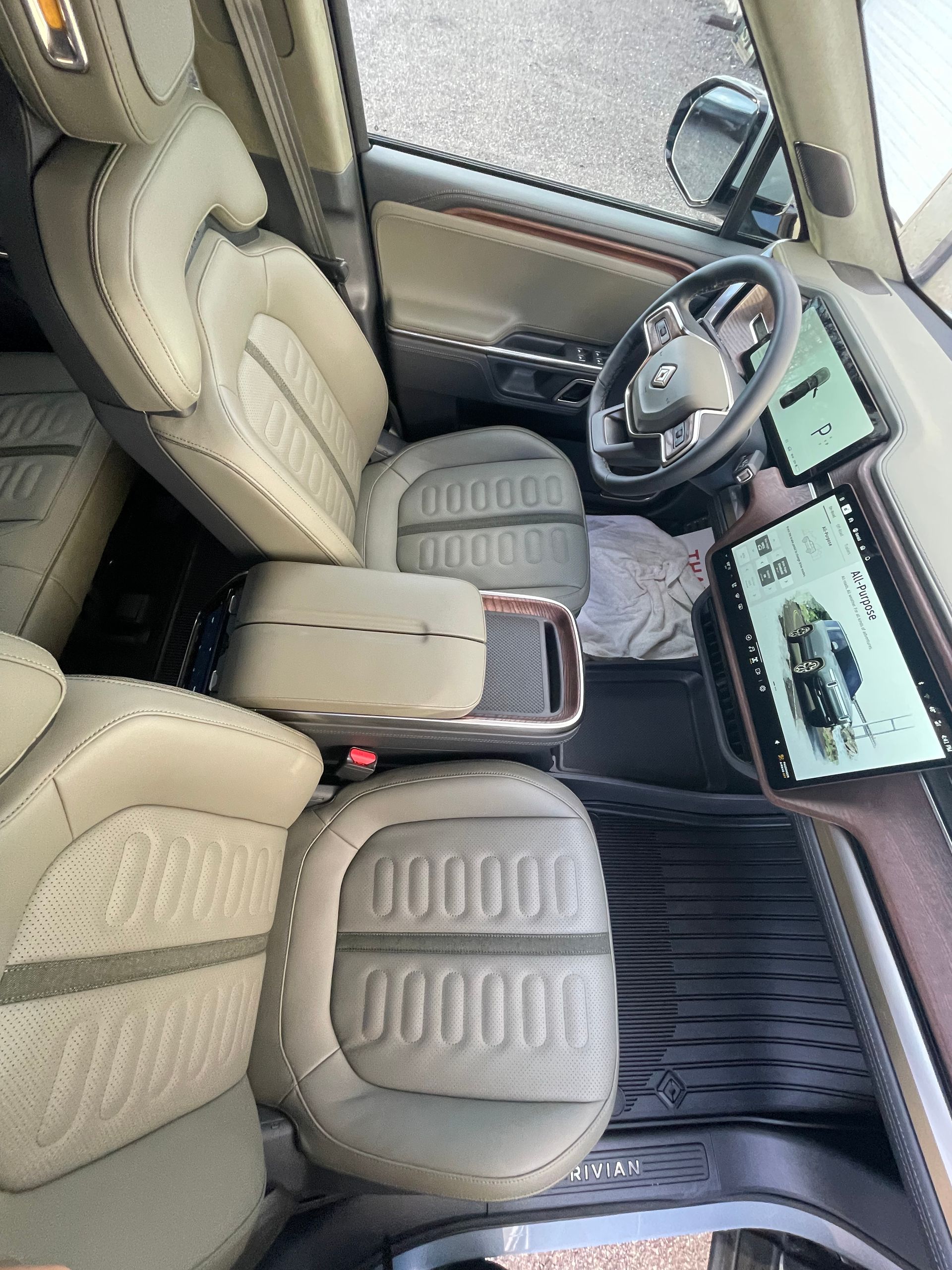 The interior of a car with leather seats and a steering wheel.