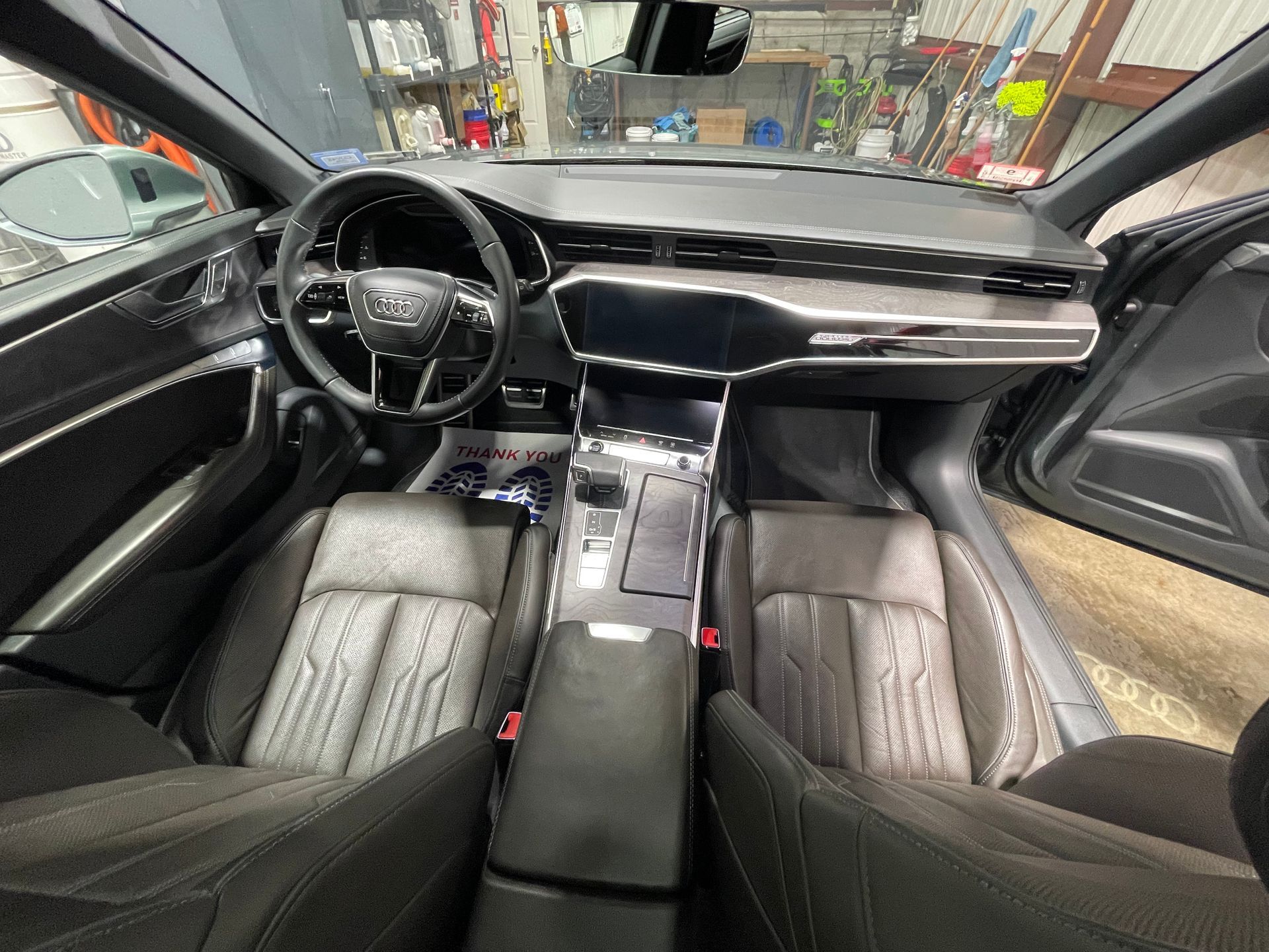 The interior of a car with a steering wheel and dashboard.