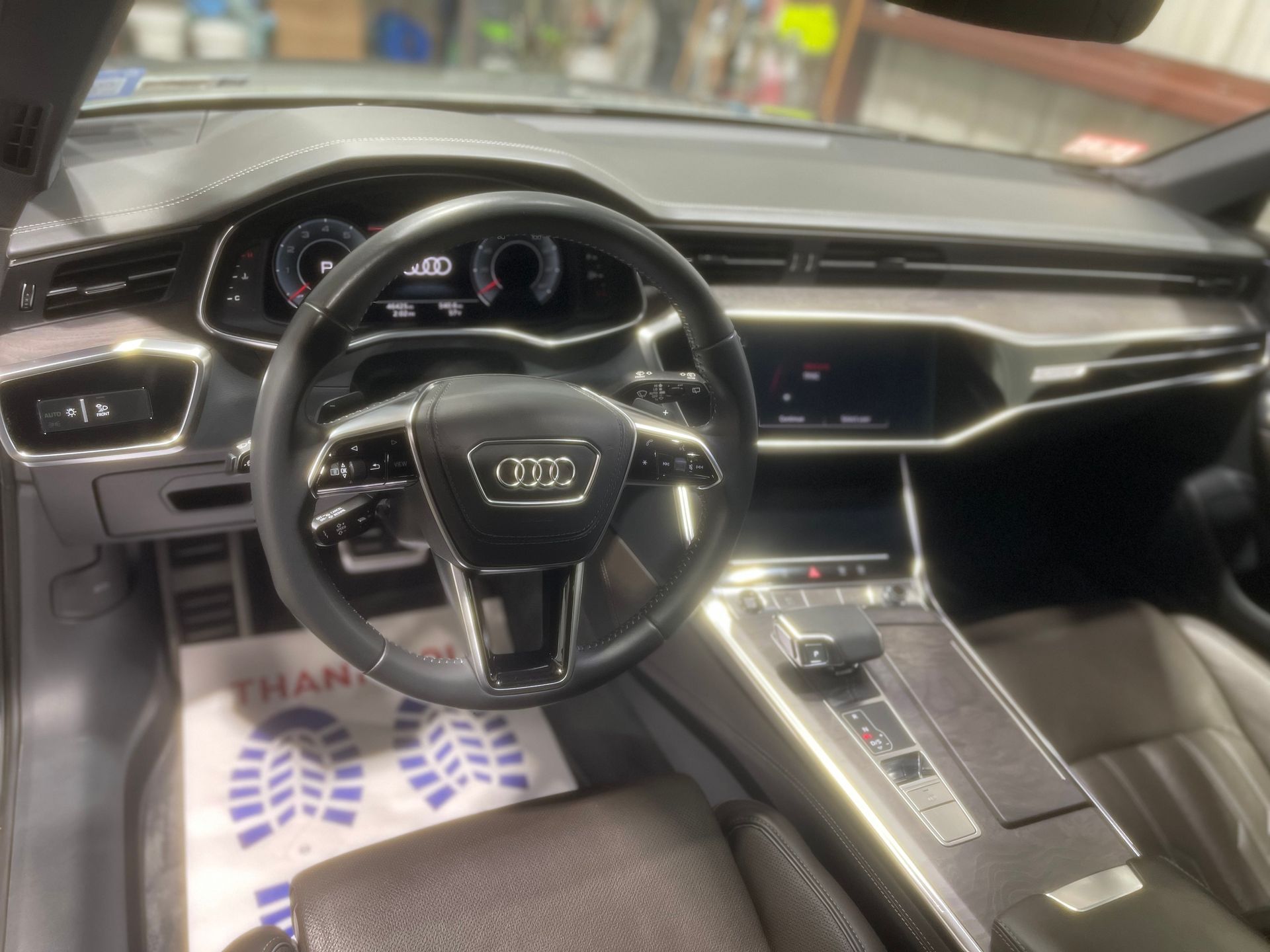 The interior of a car with a steering wheel and dashboard.