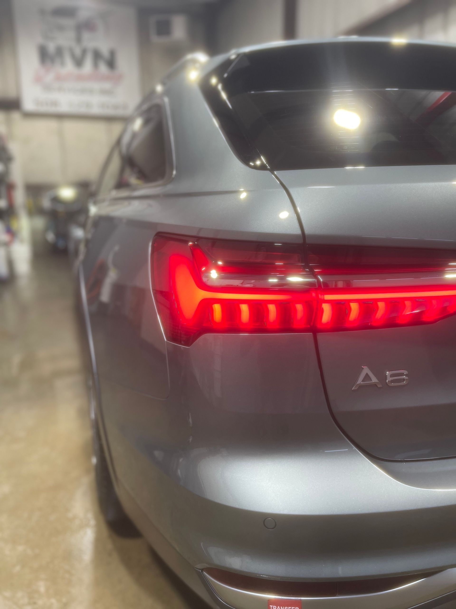 A gray car with the letters ae on the back