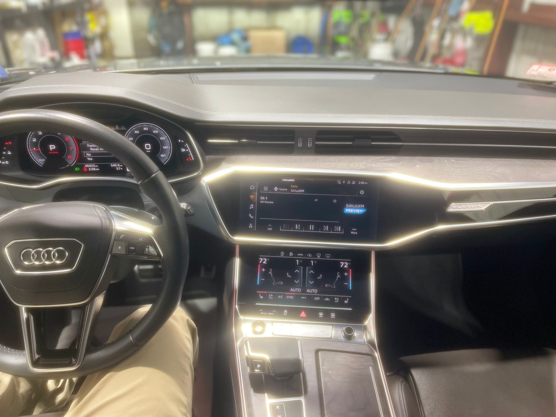 A person is sitting in the driver 's seat of an audi car