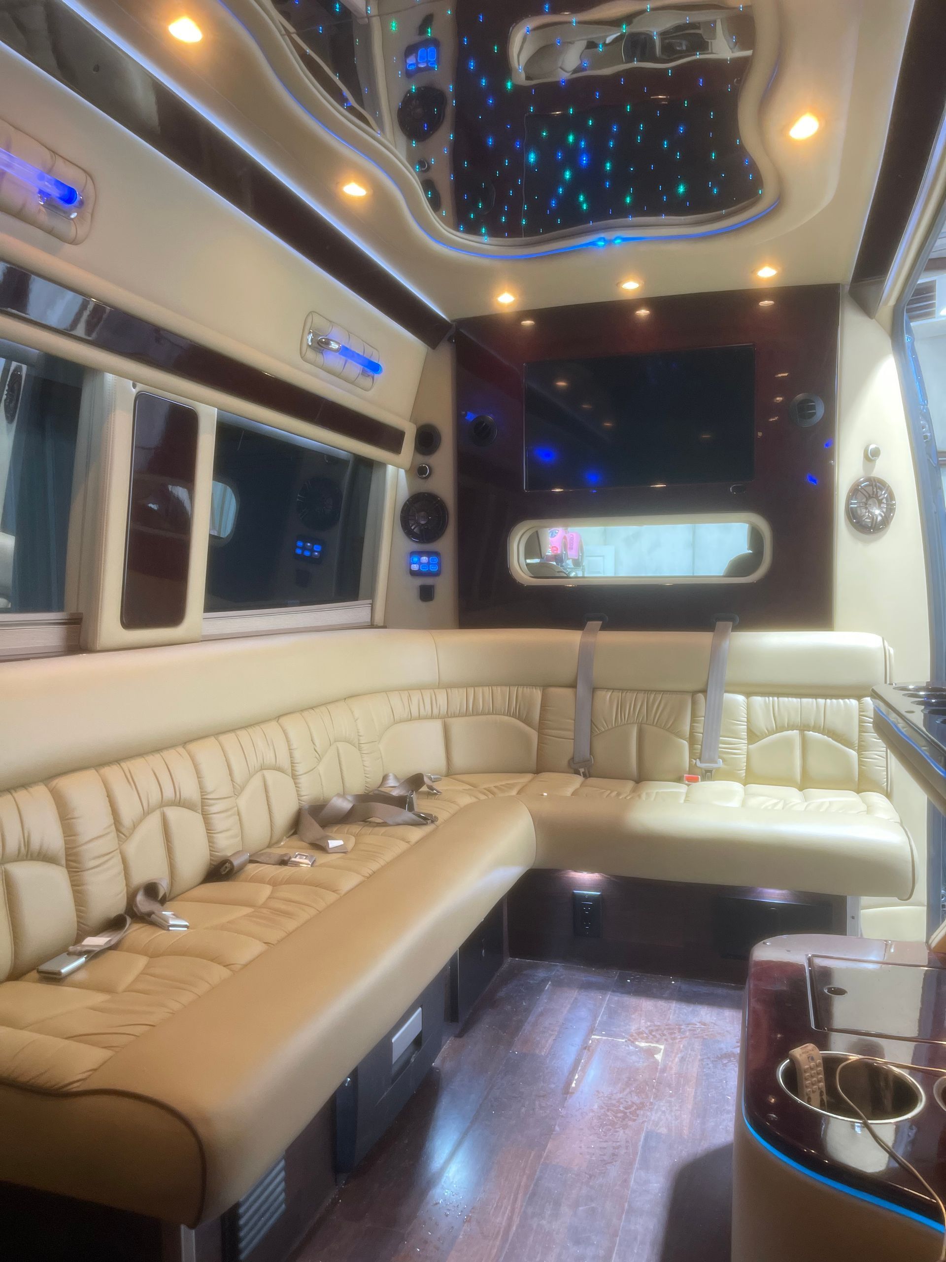 The inside of a limousine with a couch and a table