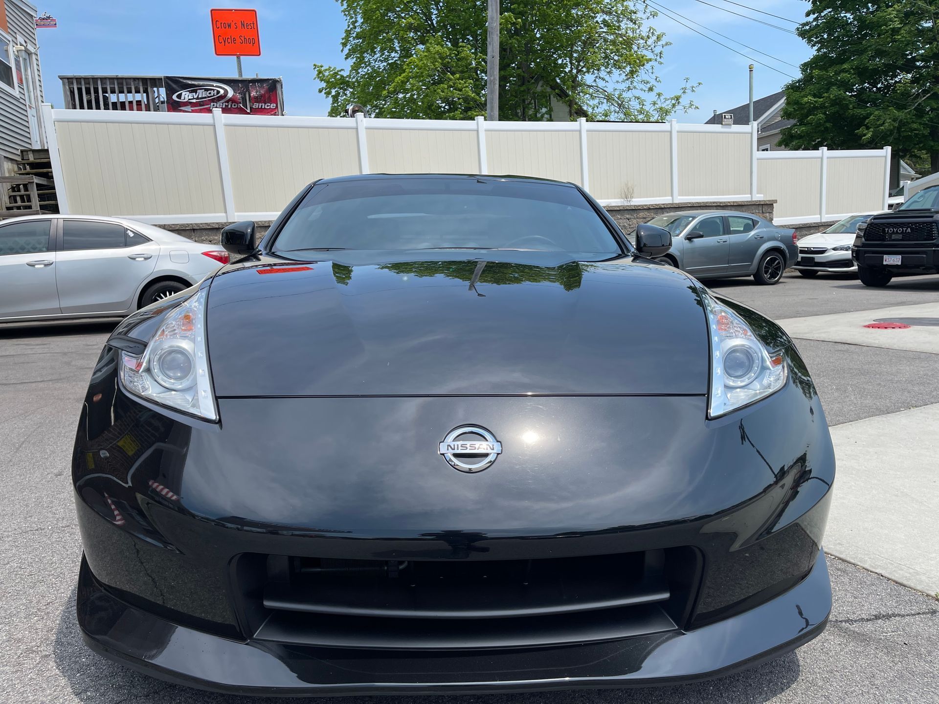 A black nissan sports car is parked in a parking lot
