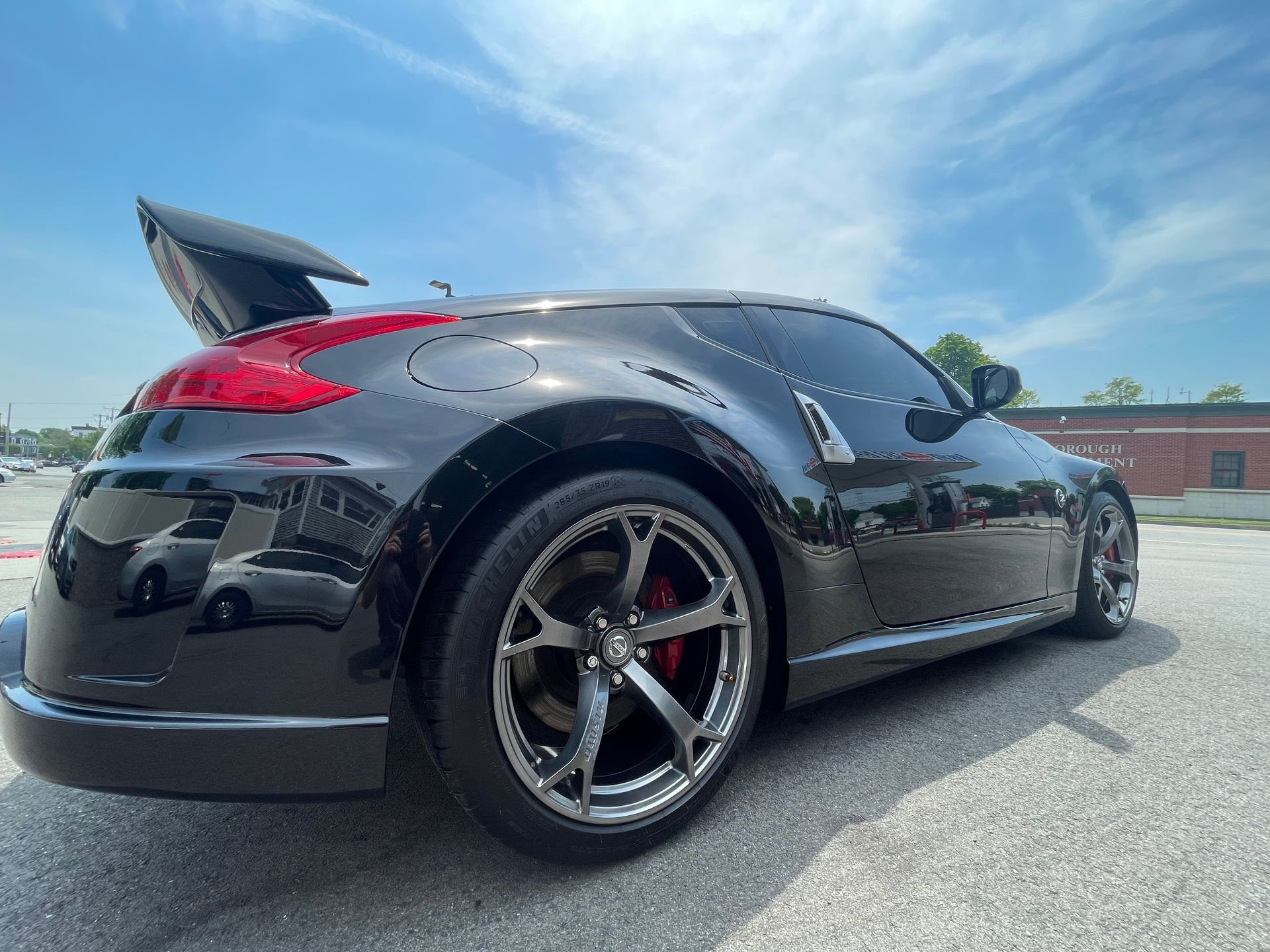 A black sports car is parked on the side of the road.